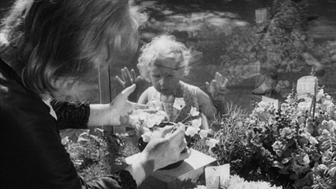 Kadrs no filmas "Baltie zvani" (1961), kadrā meitenīte un ziedu pārdevēja