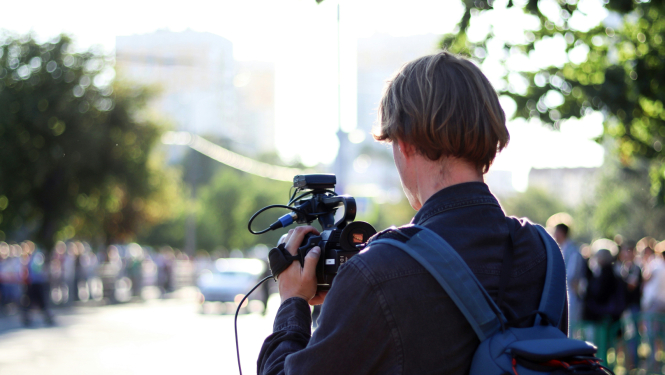TV kameras operators filmējot publisku pasākumu pilsētvidē