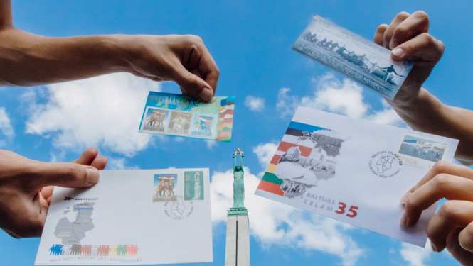 Latvijas Pasta īpašās aploksnes Baltijas ceļa 35. gadadienai uz Brīvības pieminekļa fona	
