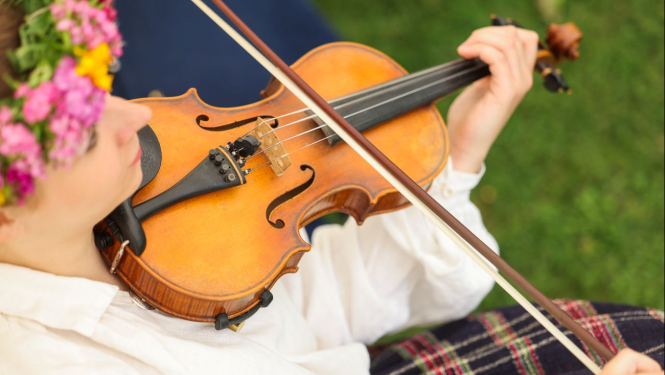 Vijolniece tautastērpā ar vijoli