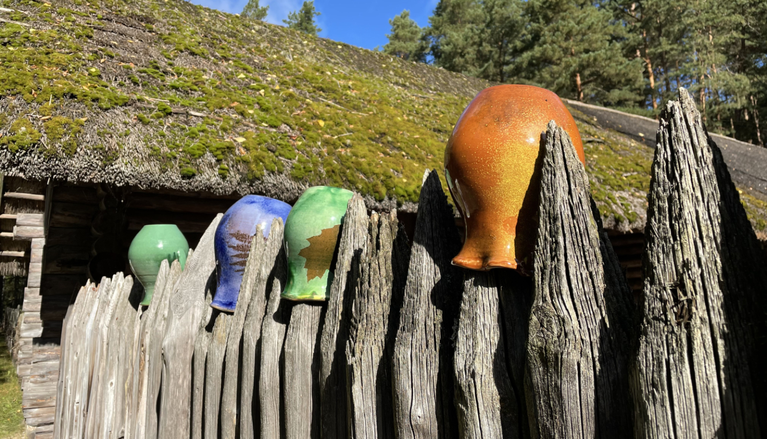 Latgales keramikas trauki uz senas koka sētas stabiem