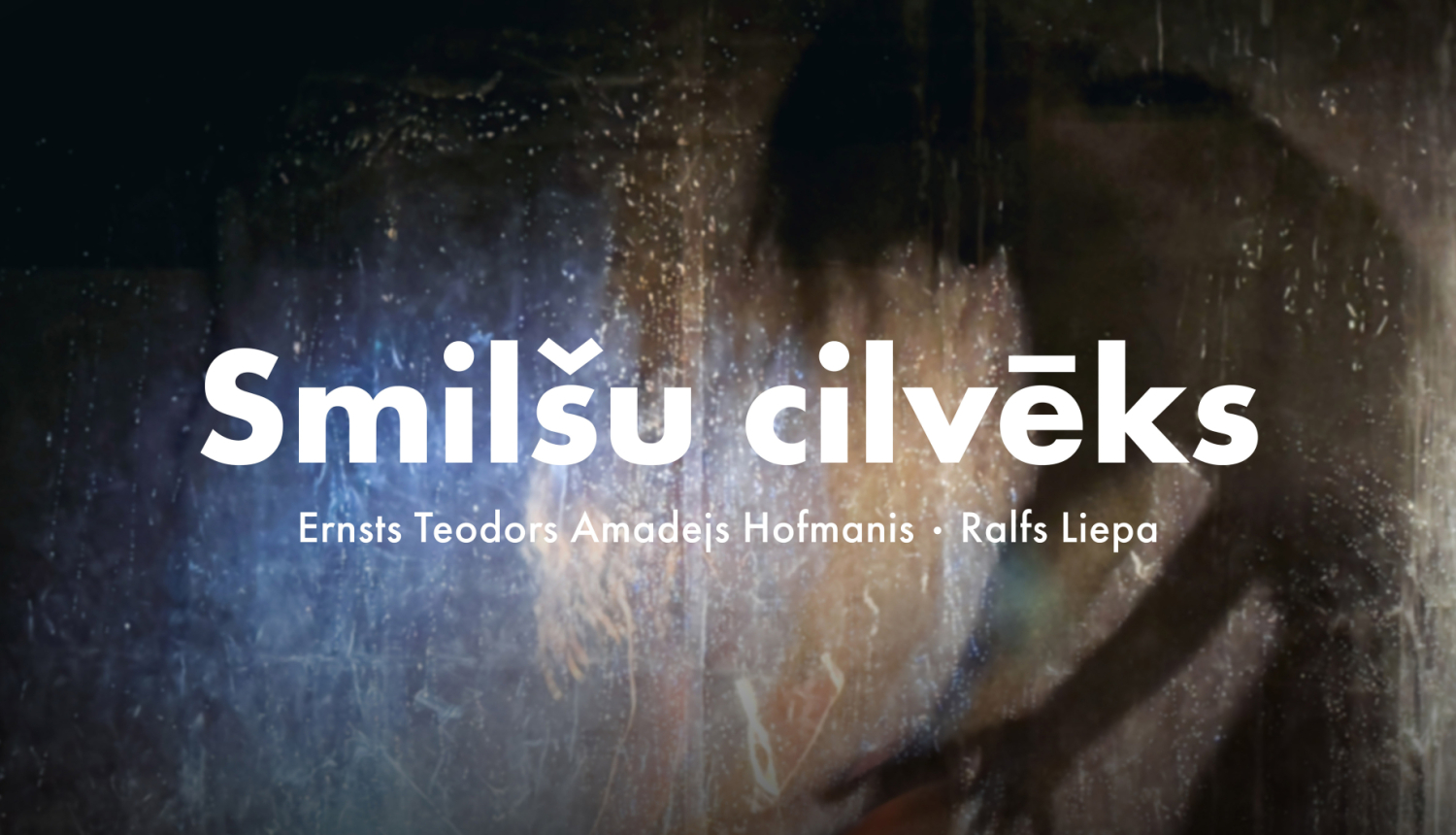 Izrāde “Smilšu cilvēks” - teksts uz abstrakta fona