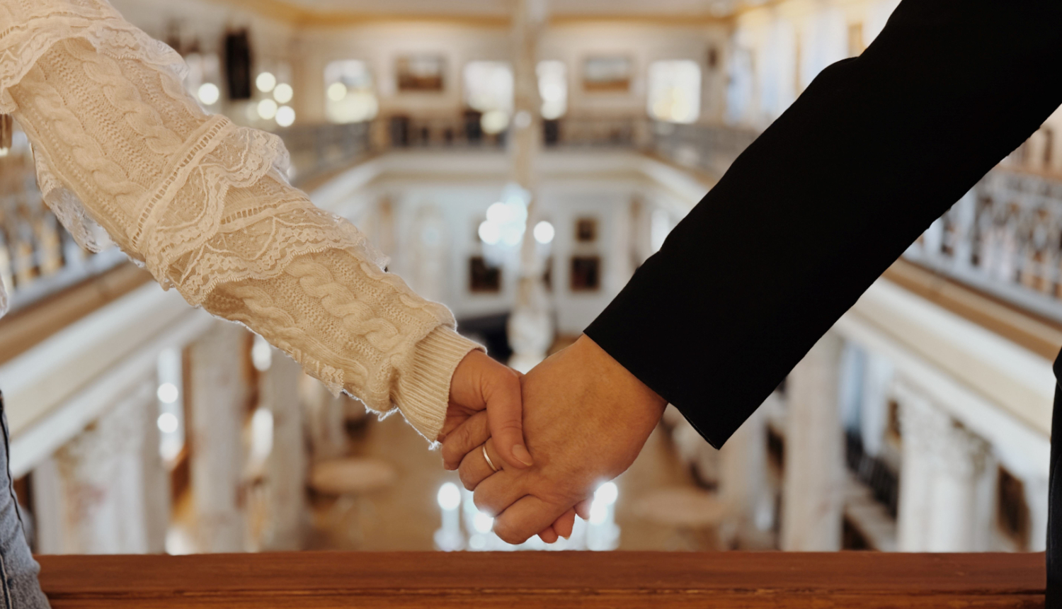 Divi cilvēki sadevušies rokās muzeja telpās