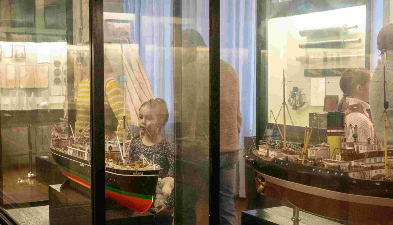 Skolēni muzejā pie vitrīnām