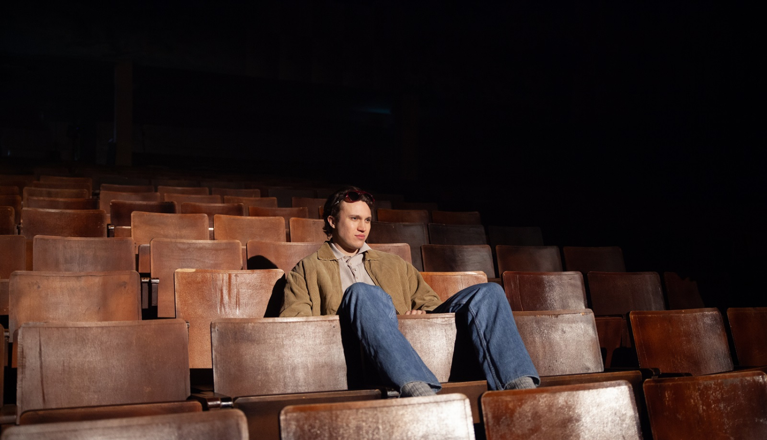 Aktieris skatītāju zālē uz krēsliem