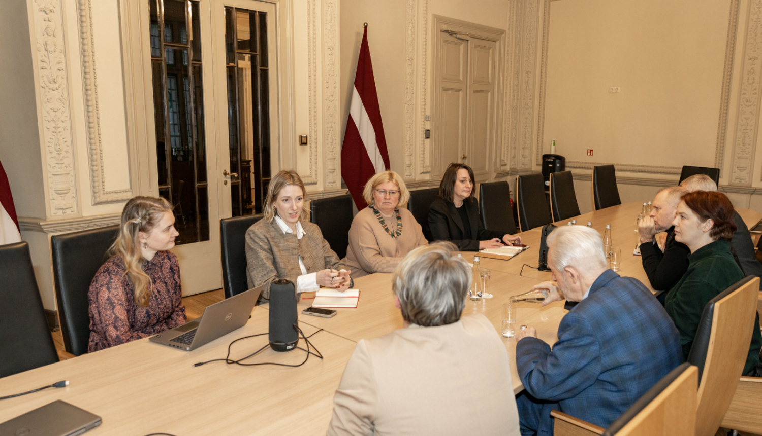 Astoņi cilvēki pie sanāksmju galda